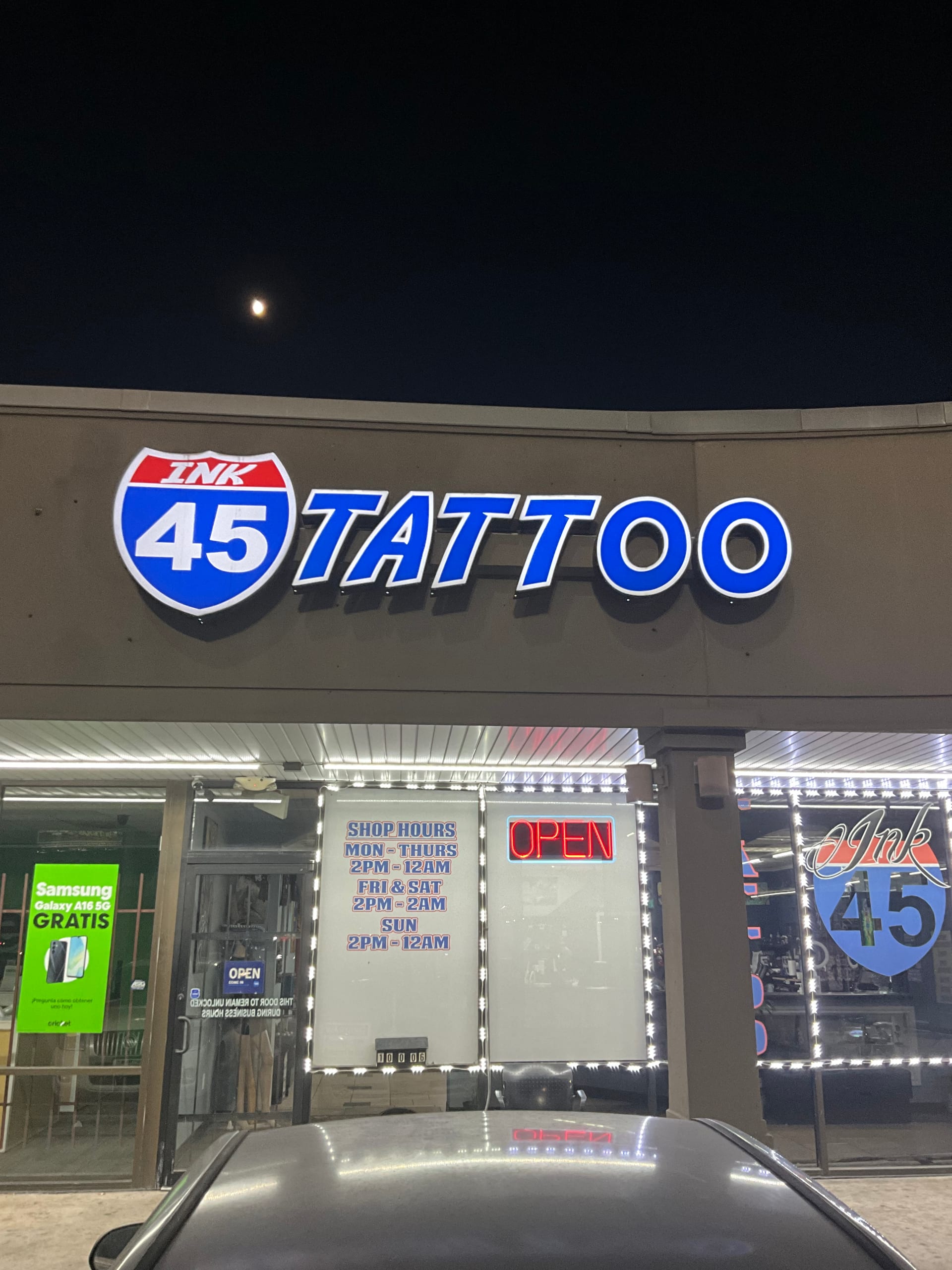 I-45 Ink storefront at night with the illuminated Ink 45 Tattoo channel-letter sign