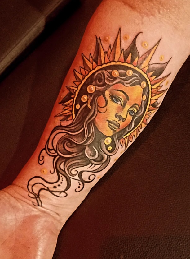 Colorful neo-traditional sun goddess tattoo on forearm